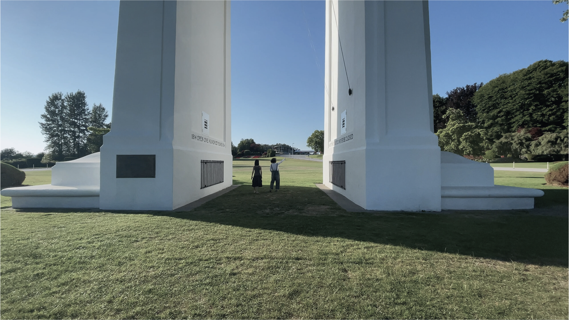 Director Yiing Wang and her sister at the Peace Arch gates